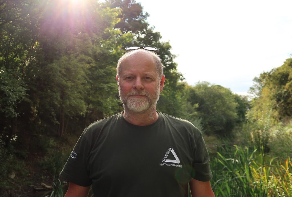 What We Do: Photo of a man in a nature setting wearing a groundwork t-shirt